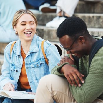 laughing friends sitting outside of school