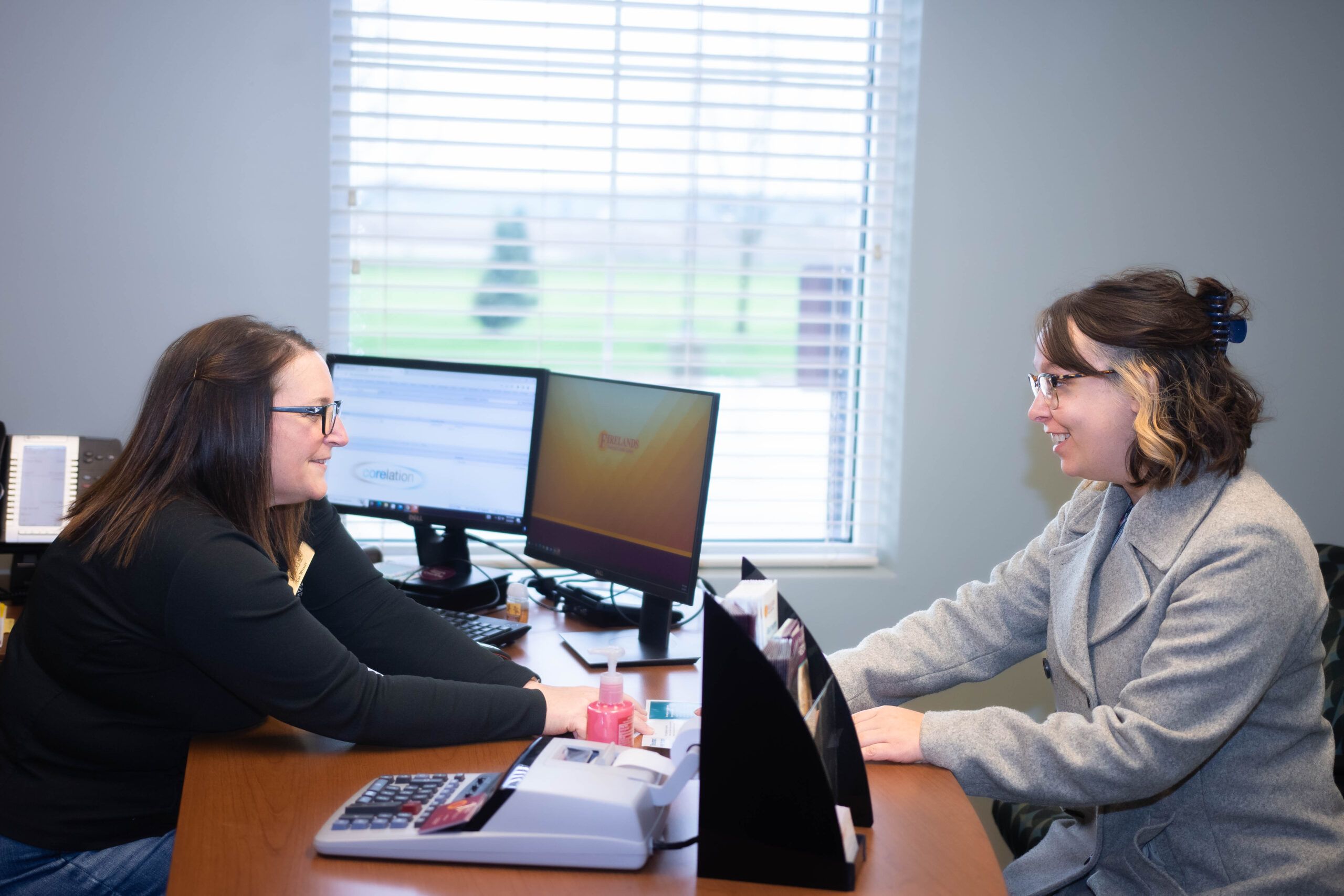 Firelands representative sitting down with a customer to answer questions on opening an account