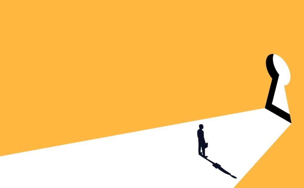 A man facing a keyhole