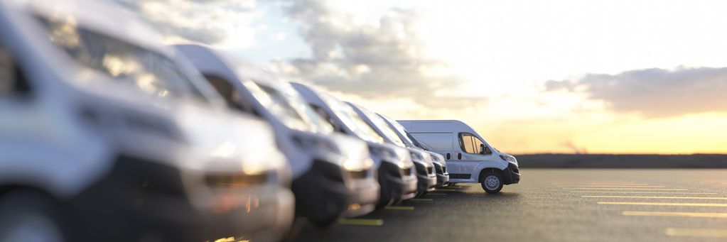 Generic row of new vans in a parking bay ready for purchase 3d render